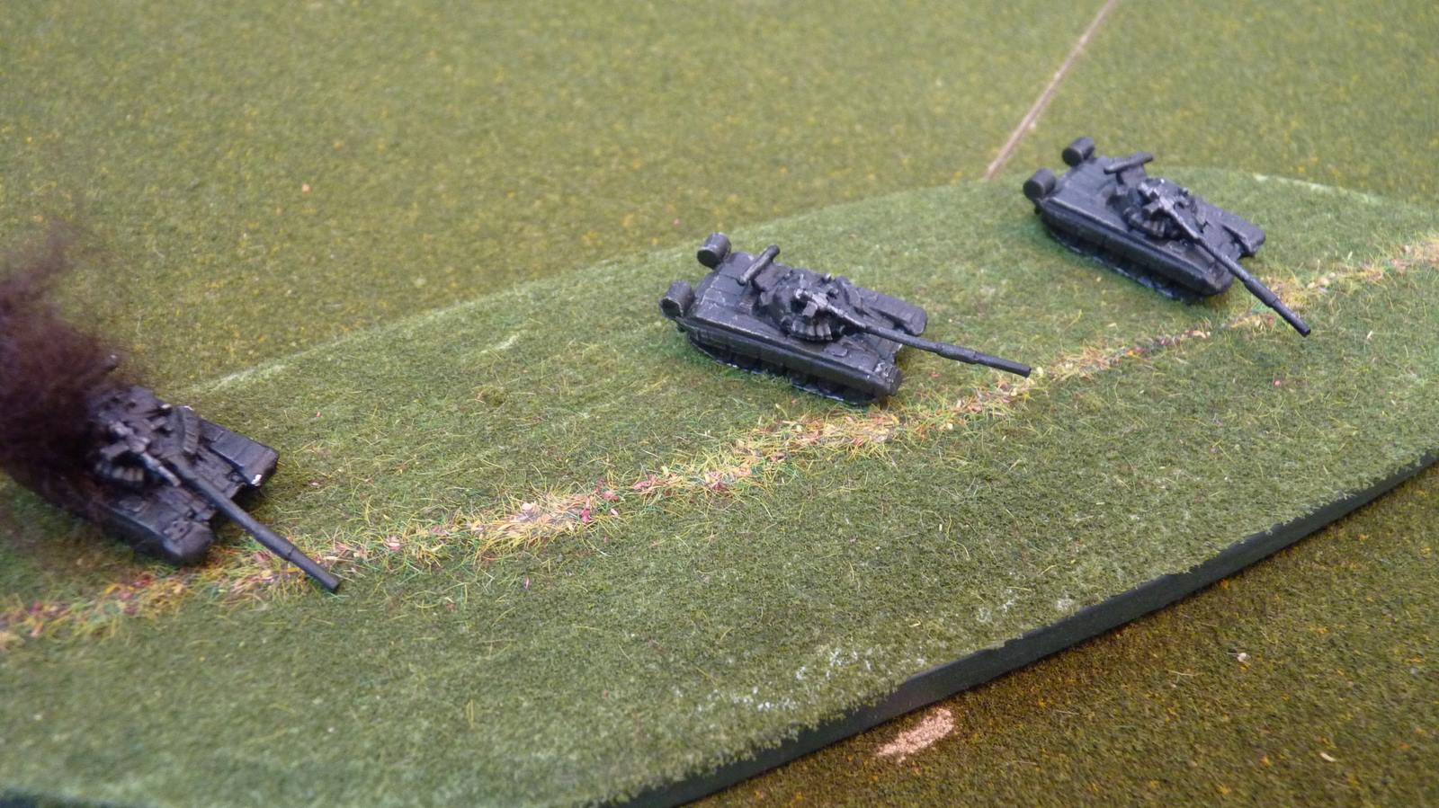 Soviet tanks move into hull down behind a ridge but one is destroyed by a missile=